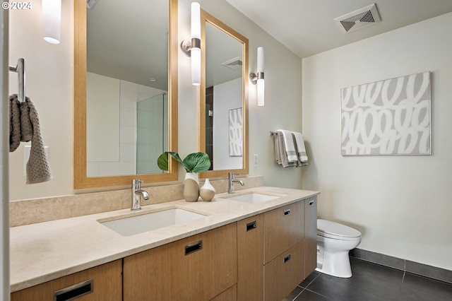 bathroom featuring toilet, vanity, and tile patterned floors