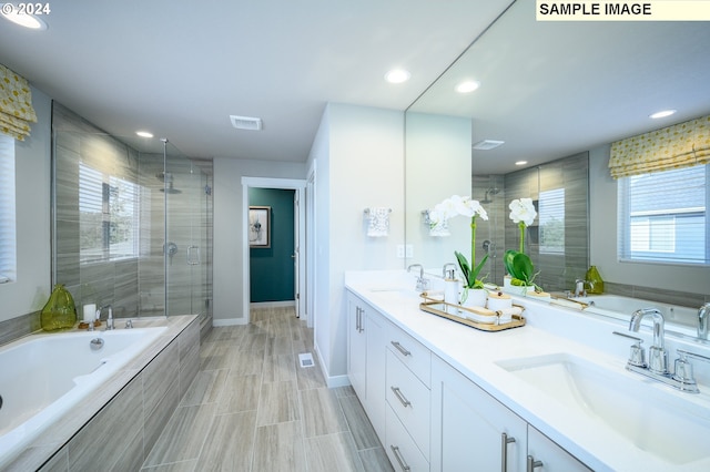 bathroom featuring vanity and separate shower and tub