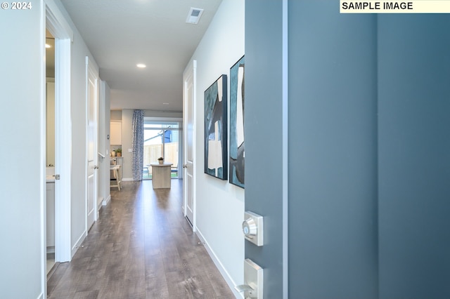 hallway with dark hardwood / wood-style flooring