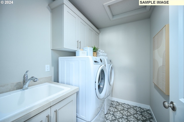 laundry area with cabinets, sink, and separate washer and dryer