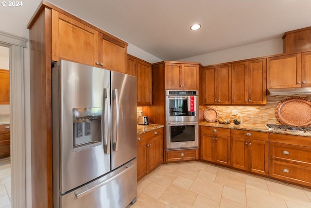 kitchen with backsplash, light stone countertops, and stainless steel appliances