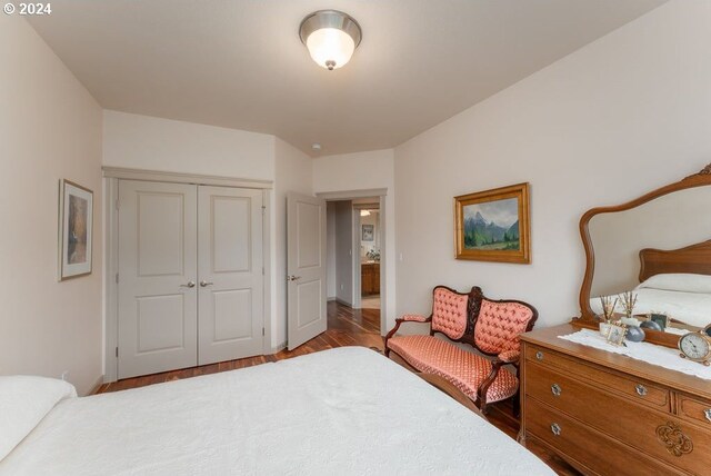 bedroom with light hardwood / wood-style floors and a closet