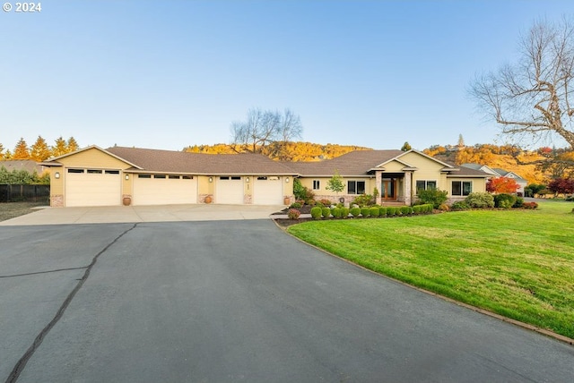 ranch-style home with a front yard and a garage