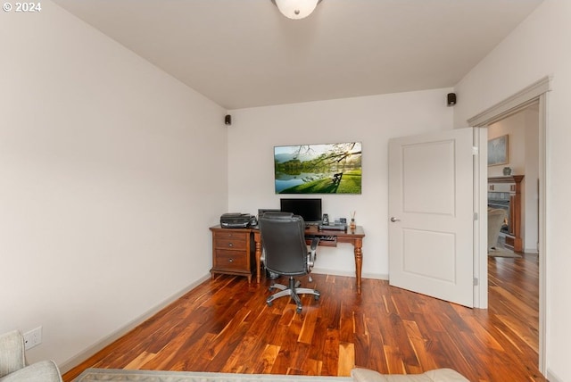 office featuring dark hardwood / wood-style flooring and a fireplace