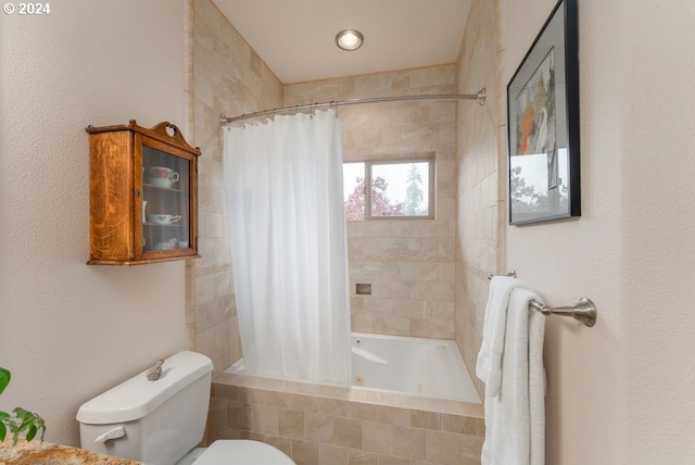 bathroom featuring shower / bath combo and toilet