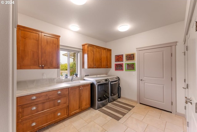 washroom with washer and clothes dryer, sink, and cabinets