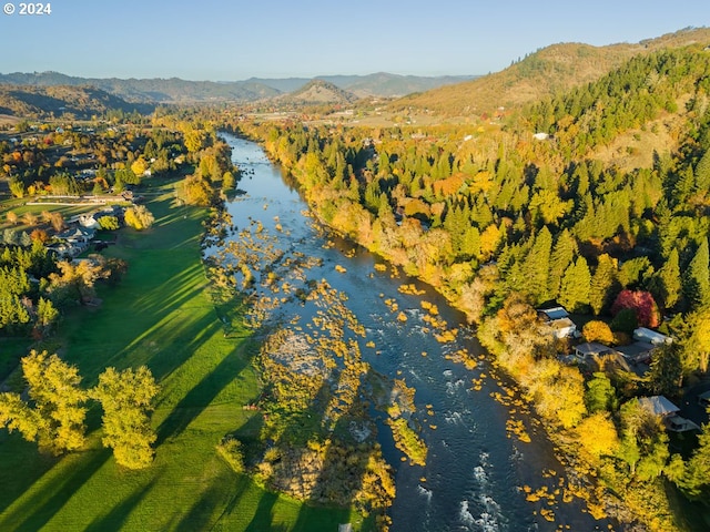 birds eye view of property with a water and mountain view