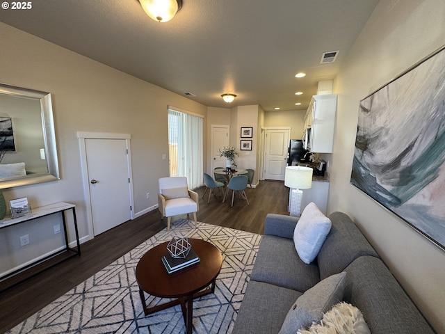 living room with dark hardwood / wood-style flooring