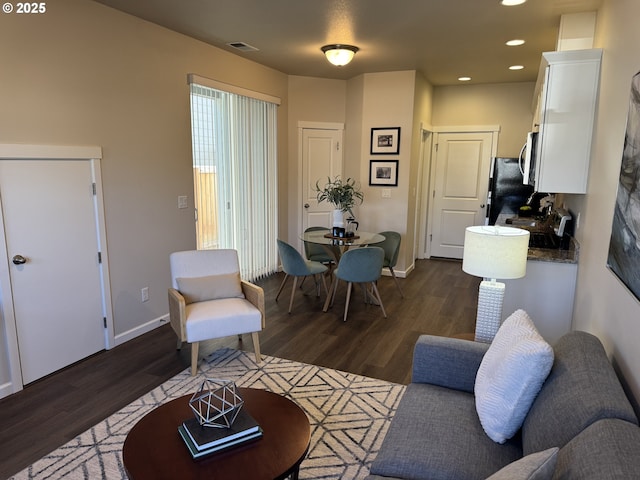 living room with dark hardwood / wood-style floors