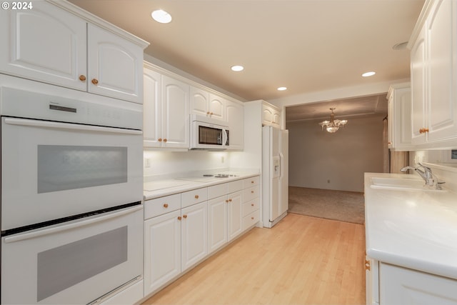 kitchen featuring white cabinets, white appliances, and a notable chandelier