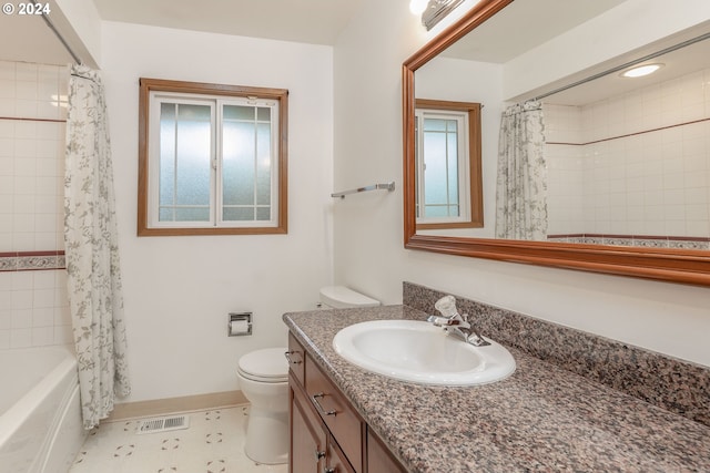 full bathroom featuring shower / bathtub combination with curtain, vanity, and toilet