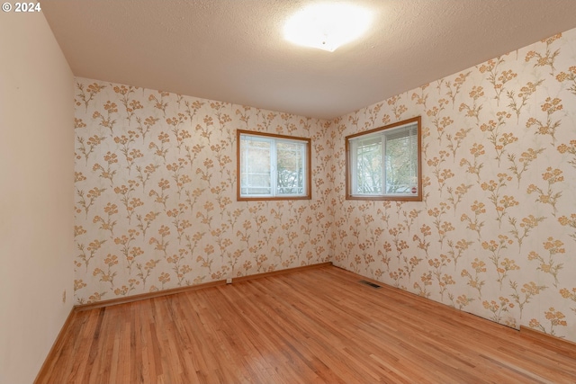 empty room featuring hardwood / wood-style floors and a textured ceiling