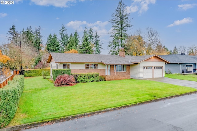 single story home featuring a garage and a front lawn