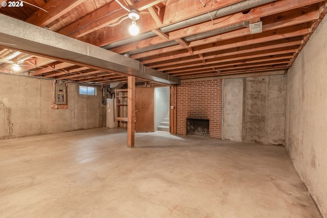 basement with a fireplace, electric panel, and water heater