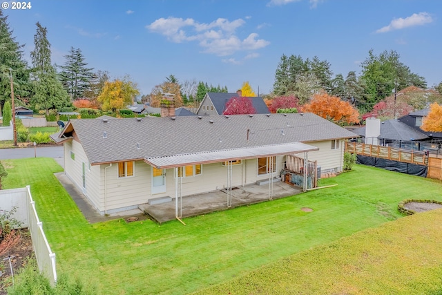 rear view of house with a patio area and a yard