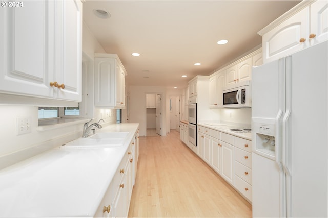 kitchen featuring light wood-type flooring, white appliances, white cabinetry, and sink