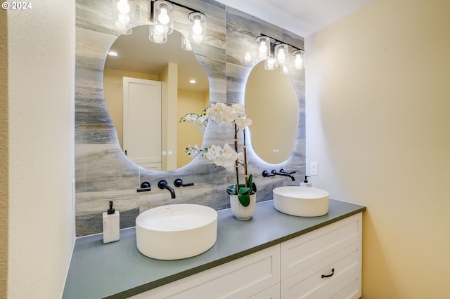 bathroom featuring vanity and tasteful backsplash