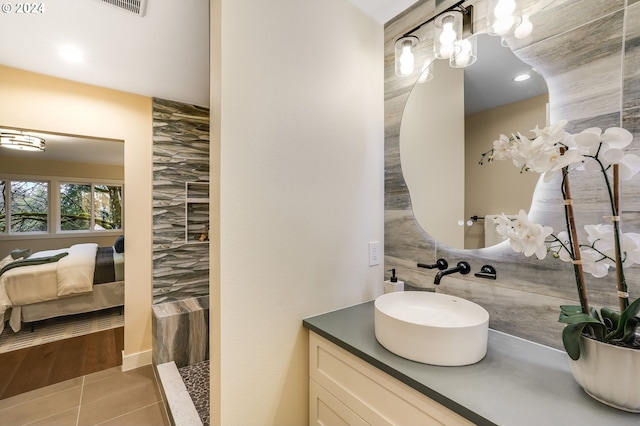 bathroom featuring tile patterned floors, vanity, and tile walls