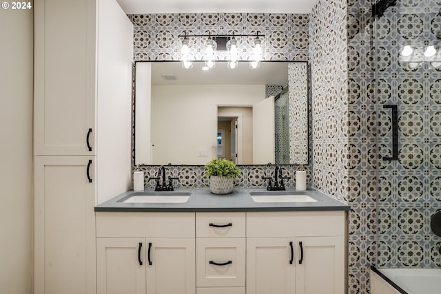 bathroom featuring vanity,  shower combination, and decorative backsplash