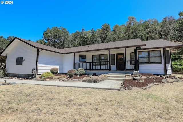 ranch-style house with a porch and a front yard