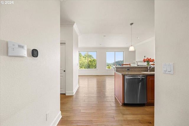 kitchen featuring dishwasher, sink, hanging light fixtures, crown molding, and hardwood / wood-style floors