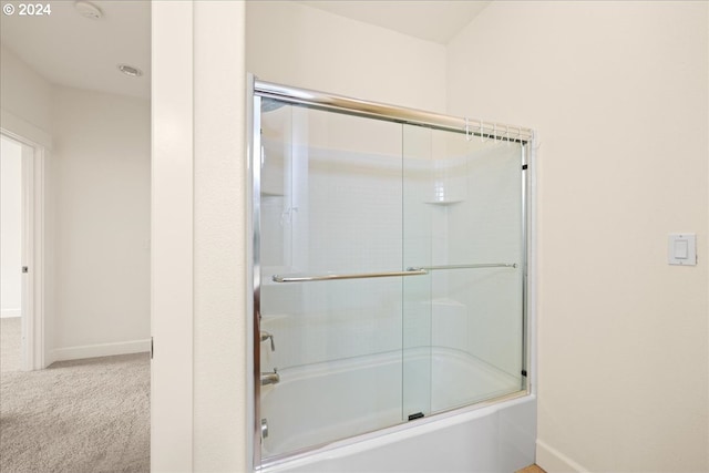 bathroom with shower / bath combination with glass door