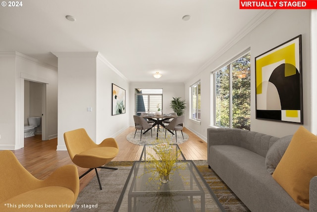 living room with hardwood / wood-style floors and crown molding