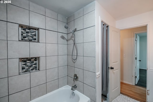 bathroom with tile patterned floors and tiled shower / bath combo