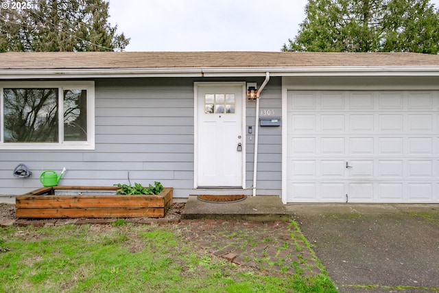 doorway to property with a garage