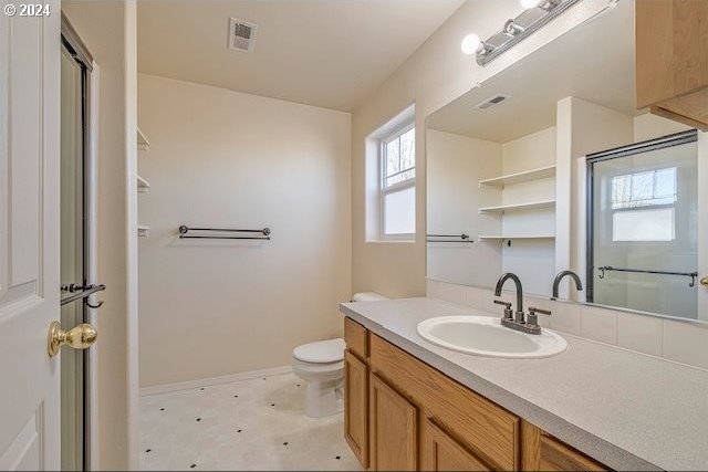 bathroom with vanity, toilet, and an enclosed shower