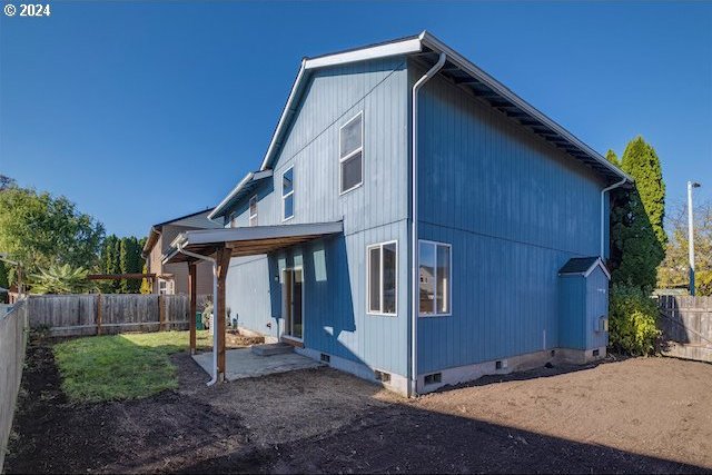 rear view of property featuring a patio