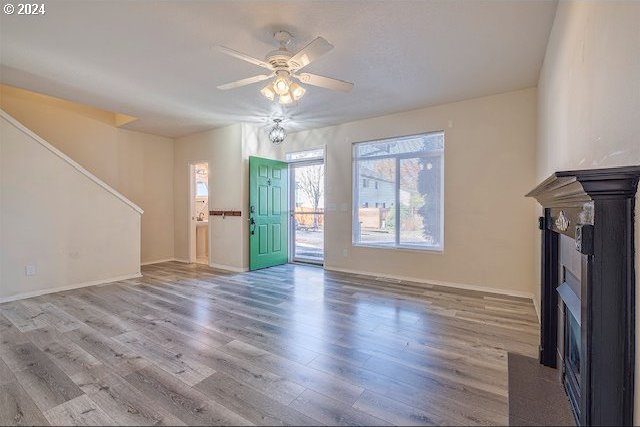 unfurnished living room featuring hardwood / wood-style flooring and ceiling fan