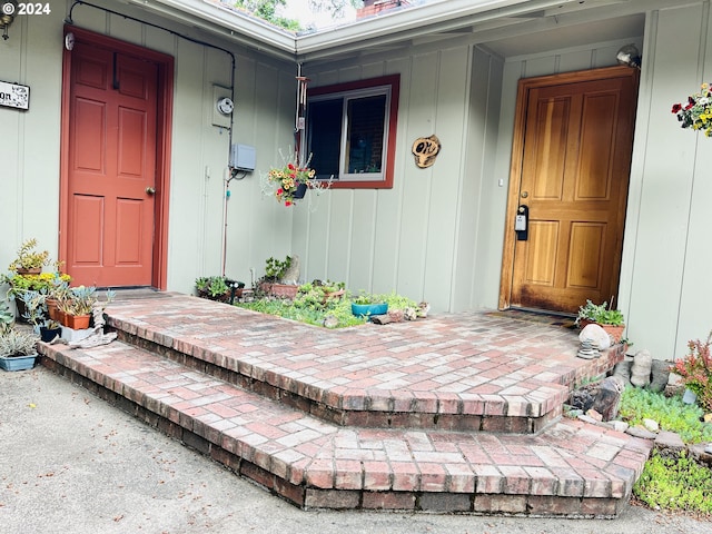 242 Rocky Point Ln, Roseburg, OR 97471 - view of exterior entry featuring covered porch, a chimney, and board and batten siding