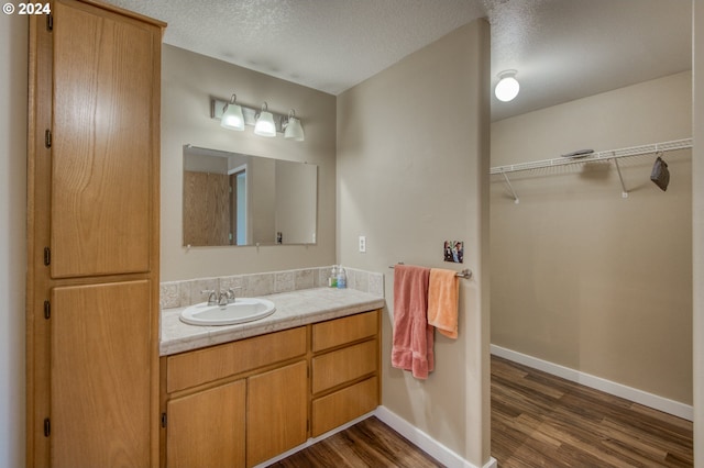 bathroom featuring vanity, a textured ceiling, and hardwood / wood-style flooring