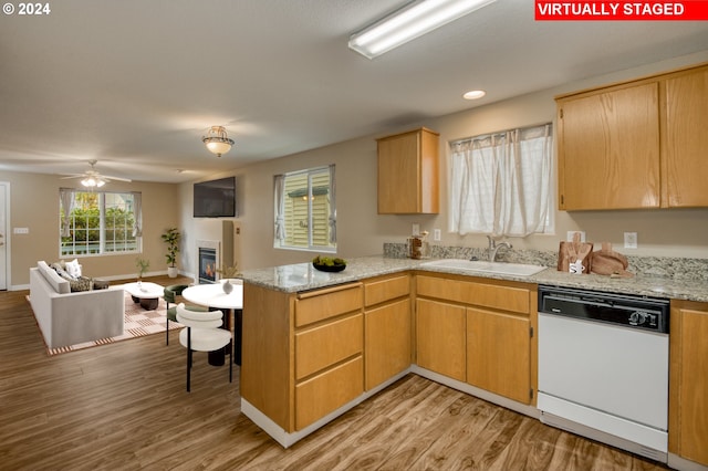 kitchen with dishwasher, kitchen peninsula, sink, light wood-type flooring, and ceiling fan