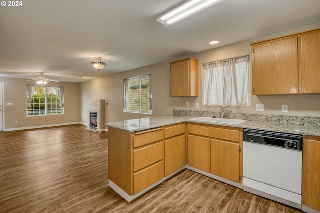 kitchen featuring sink, light wood-type flooring, dishwasher, and kitchen peninsula