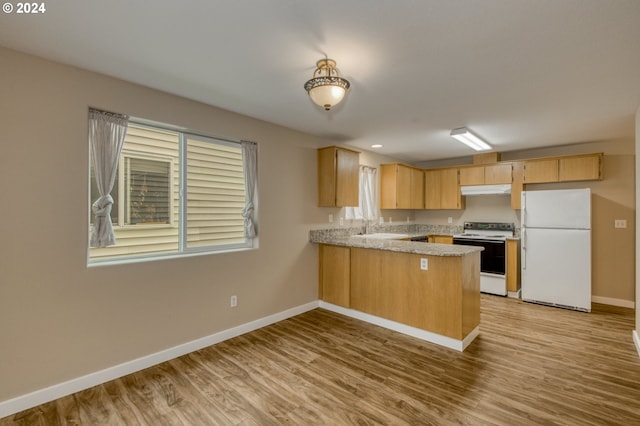 kitchen featuring light brown cabinets, kitchen peninsula, white appliances, sink, and light hardwood / wood-style floors