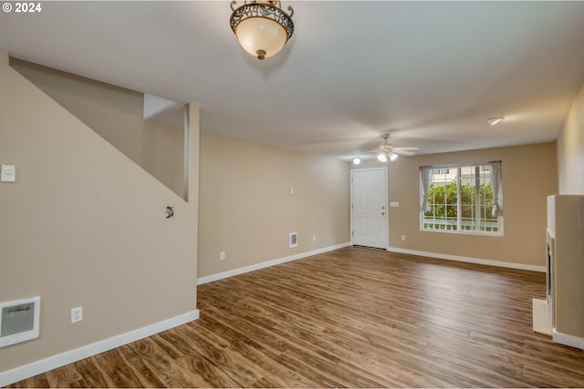 unfurnished room with ceiling fan and wood-type flooring