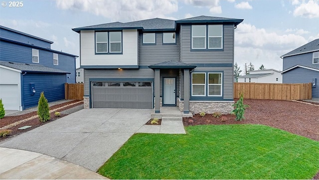 view of front of property featuring a front yard and a garage