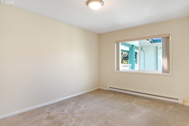 carpeted spare room featuring a baseboard heating unit