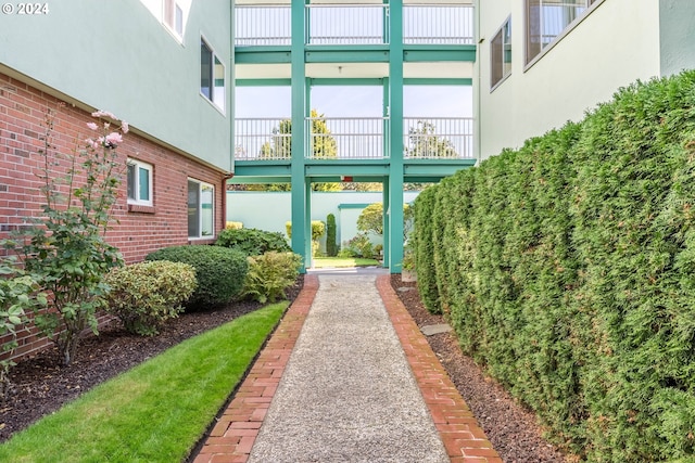 view of exterior entry featuring a balcony