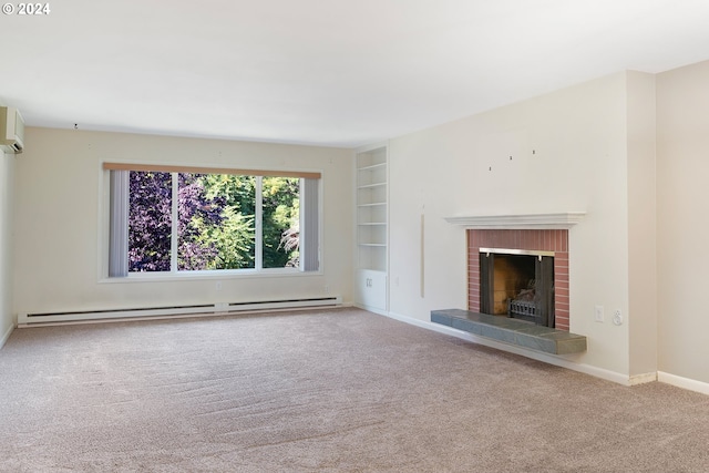 unfurnished living room featuring a baseboard heating unit, an AC wall unit, built in shelves, carpet floors, and a brick fireplace