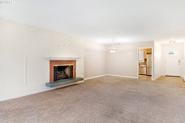 unfurnished living room featuring light carpet and a brick fireplace