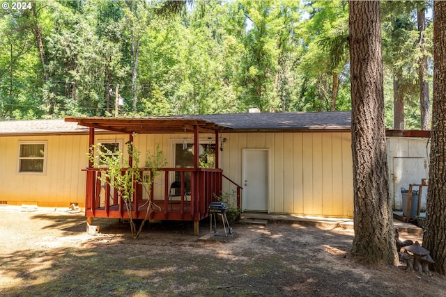 back of property with a wooden deck