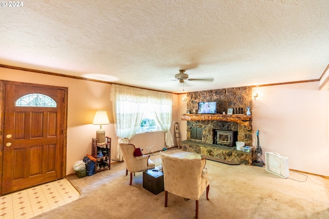 carpeted living room with a textured ceiling, ceiling fan, and ornamental molding