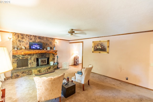 carpeted living room featuring a wood stove, ceiling fan, and ornamental molding