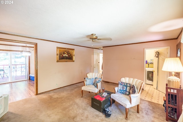 sitting room with carpet flooring, washer / dryer, ceiling fan, and ornamental molding