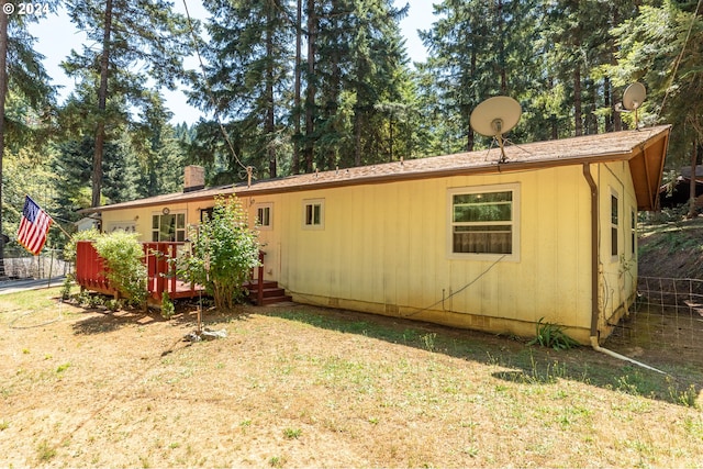 back of property featuring a deck