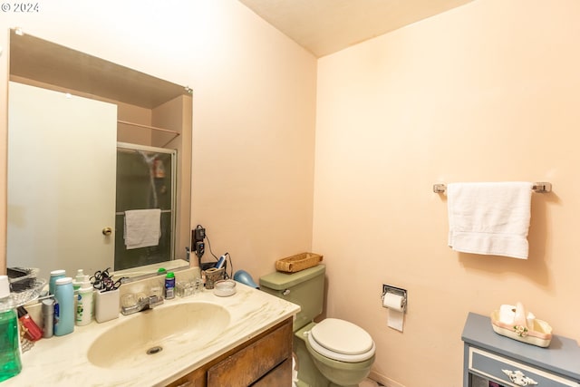 bathroom with vanity, toilet, and walk in shower