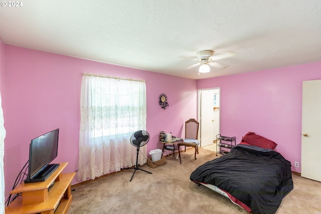 bedroom with ceiling fan and light carpet